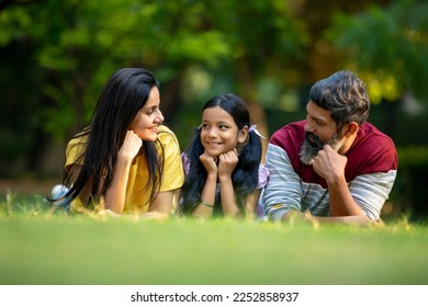 Happy indian couple with his little daughter at garden. - Powered by Shutterstock