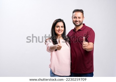 Happy indian couple on white background.