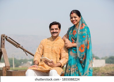 Happy Indian couple in traditional clothing at village
