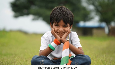 Happy Indian Cute Smiling little boy waving tricolor flag at outdoor park, celebrating Independence day or Republic day. - Powered by Shutterstock