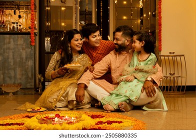 Happy Indian Family Celebrating Diwali at Home with Traditional Attire - Powered by Shutterstock