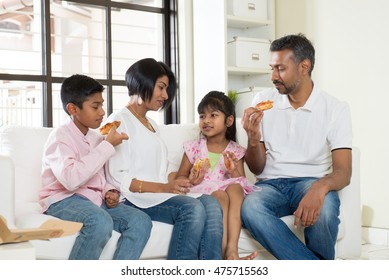 Happy Indian Family Eating Pizza At Home