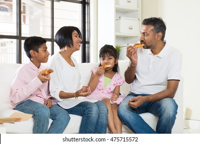 Happy Indian Family Eating Pizza At Home