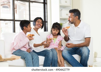 Happy Indian Family Eating Pizza At Home

