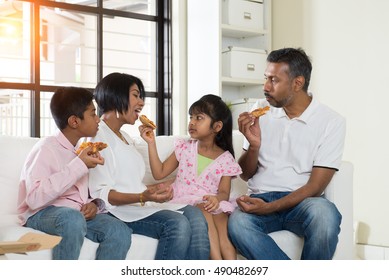 Happy Indian Family Eating Pizza At Home

