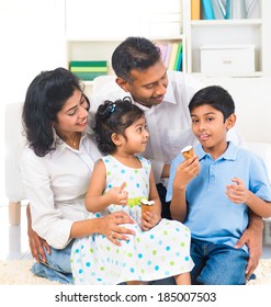 Happy Indian Family Enjoying Eating Ice Cream Indoor