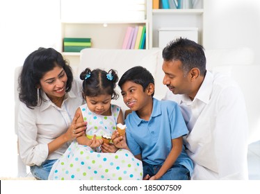 Happy Indian Family Enjoying Eating Ice Cream Indoor