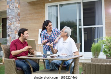 Happy Indian family enjoying media content on digital tablet