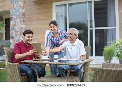 Happy Indian Family Enjoying Media Content On Digital Tablet