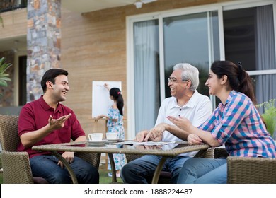 Happy Indian Family Enjoying Media Content On Digital Tablet