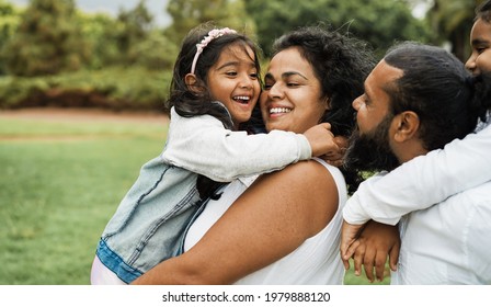 Happy Indian Family Having Fun Outdoor - Hindu Parents Laughing With Their Children At City Park - Love Concept - Main Focus On Mother And Daughter Face