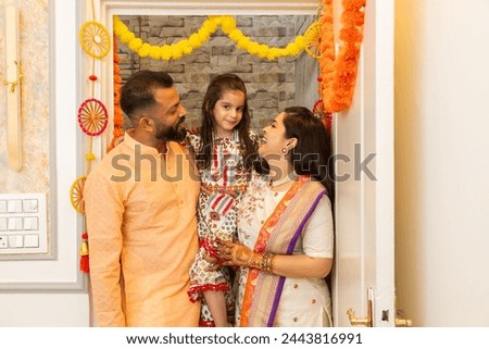 Happy indian family of three entering new house for the first time. festival purchase , family relationship concept