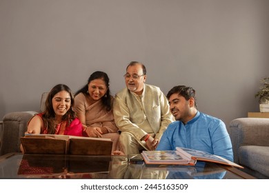 Happy Indian family watching photo album together at home
 - Powered by Shutterstock