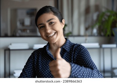 Happy Indian female employee, student girl showing thumb up, smiling at camera. Satisfied client making recommend like gesture, giving good positive feedback, expressing enthusiasm. Head shot portrait - Powered by Shutterstock