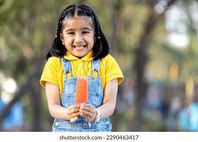 Happy indian kid enjoying ice cream  - Powered by Shutterstock