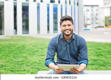 Happy Indian Male Student With Tablet