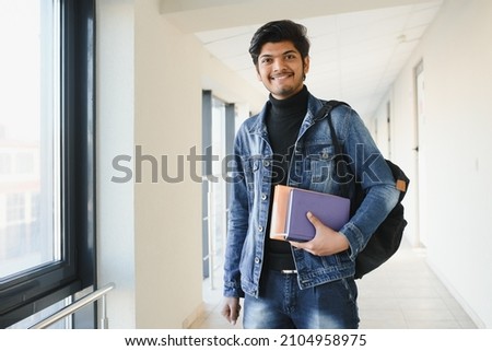 Happy indian male student at the university