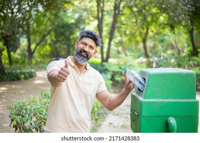 Happy Indian Man Throw Empty Litter In Recycling Bin And Do Thumbs Up In Hand, Asian Male Drop Plastic Bottle Into Garbage Bin, Pollution Or Waste Management And Save Environment Concept.
