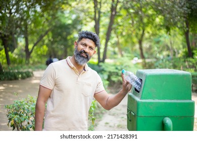 Happy Indian Man Throw Empty Litter In Recycling Bin, Asian Beard Male Drop Plastic Bottle Into Garbage Bin, Pollution Or Waste Management And Save Environment Concept.