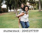 Happy indian mother having fun with her daughter outdoor - Focus on mother face