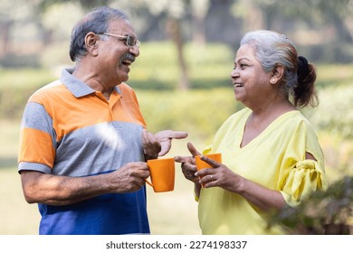 Happy indian senior couple enjoying life having fun at park - Powered by Shutterstock