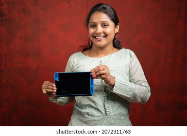 Happy Indian Woman Holding Tab By Looking Camera - Concept Online Advertisement And Shopping Promotion During Festival Season