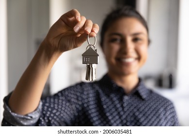 Happy Indian Woman Ready To Move Into New Home. Real Estate Agent Offering Rent Or Buying House, Flat, Apartment, Help With Loan And Mortgage. Hand Of Buyer Or Home Owner Holding Key. Closeup