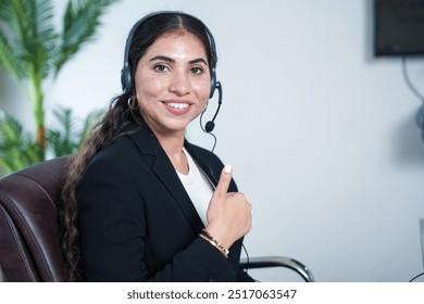 Happy indian woman service support operator or agent showing thumbs up wearing headset looking at camera. call center and business communication concept. - Powered by Shutterstock