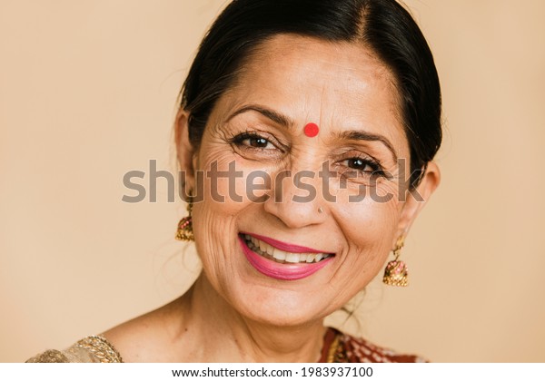 Happy Indian woman wearing a\
bindi
