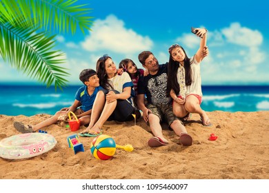 Happy Indian/Asian Family Playing At The Beach. Summer Vacation Concept