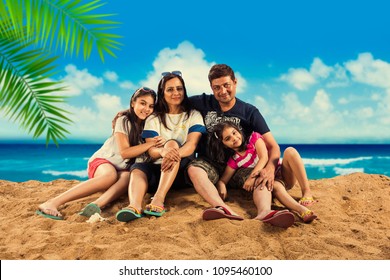 Happy Indian/Asian Family Playing At The Beach. Summer Vacation Concept