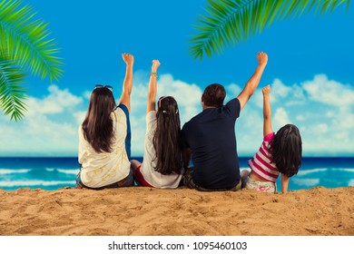 Happy Indian/Asian Family Playing At The Beach. Summer Vacation Concept