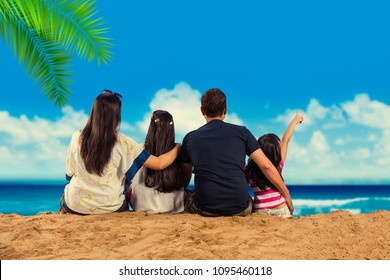 Happy Indian/Asian Family Playing At The Beach. Summer Vacation Concept