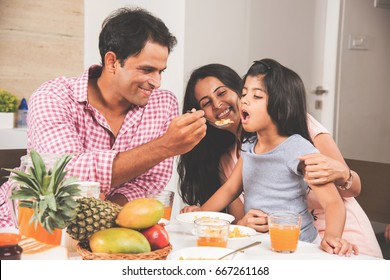 Happy Indian/Asian Young Family Dining At Home And Having Fun. Selective Focus