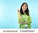 A happy Indonesian (Asian) girl caught an idea on a blue isolated background