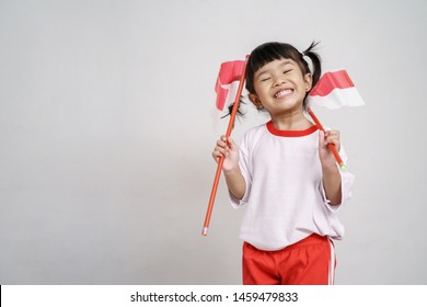 Happy Indonesian Kid With Flag Over White Background