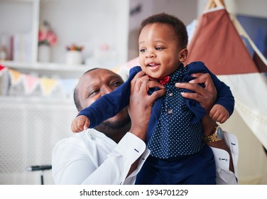 Happy Infant Baby Boy In Father's Strong Hands, Having Fun Together