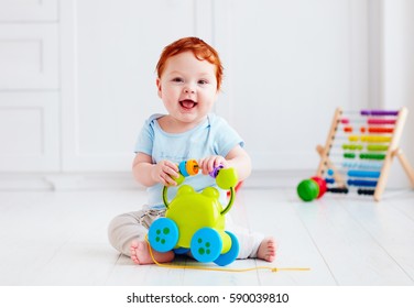 Happy Infant Baby Boy Playing With Toys At Home