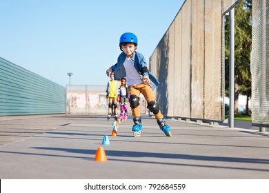 Happy Inline Skater Slaloming At Skate Park