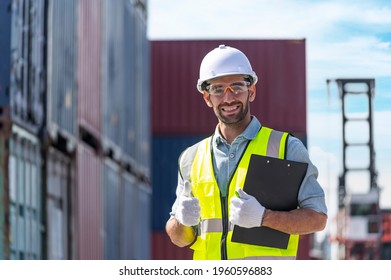 happy inspector working working with checking list of shipping container with smile service in commercial transport port  - Shutterstock ID 1960596883