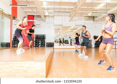 Happy Instructors And Friends Exercising In A Dance Class At A Health Club