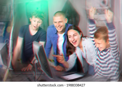 Happy Interested Family With Teen Sons Trying To Get Out Of Closed Space Of Escape Room Stylized As Abandoned Bunker, Using Computer. Toned Image With Color Visuals..