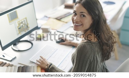 Happy interior designer working with a 3D software and smiling