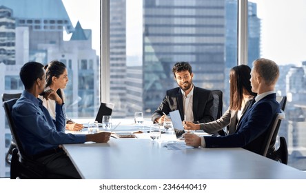 Happy international multiethnic professional business team, diverse executive colleagues people discussing financial project working together in office at group meeting table in corporate board room. - Powered by Shutterstock