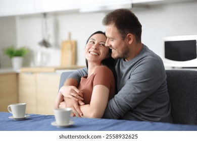 Happy interracial couple flirting in the kitchen looking each other at home - Powered by Shutterstock