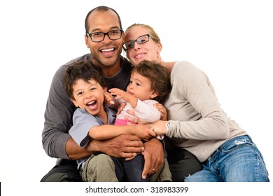 Happy interracial family is celebrating, laughing and having fun with Hispanic African American Father, Caucasian mother and children son and daughter.  Isolated on white.