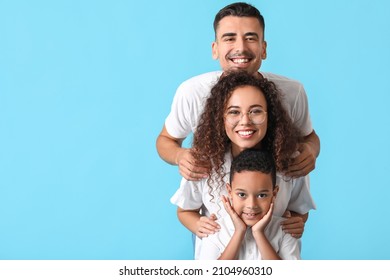 Happy interracial family on color background - Shutterstock ID 2104960310