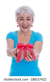 Happy Isolated Older Woman Holding A Gift Box In Her Hands.