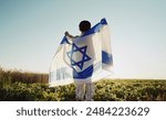 Happy Israeli Jewish Little Boy Jumping, Israel National Flag. Independence Day. Patriotism. Symbol of democracy, independence, future. High quality