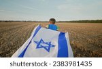 Happy Israeli Jewish little cute boy running with Israel national flag. Independence Day. Patriotism. High quality photo